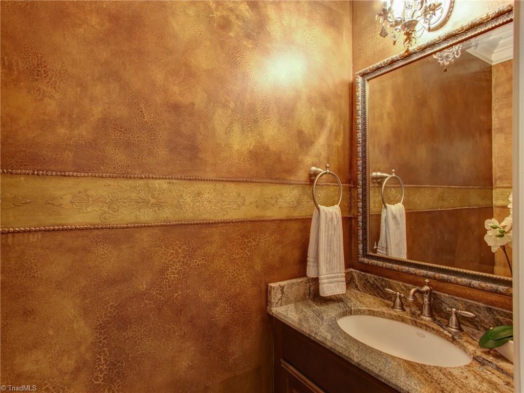 8404 Oakchester Court Oak Ridge, NC 27310 - Photo 7 of 30 Beautiful designed powder room with crown molding, chandelier and faux painted walls.