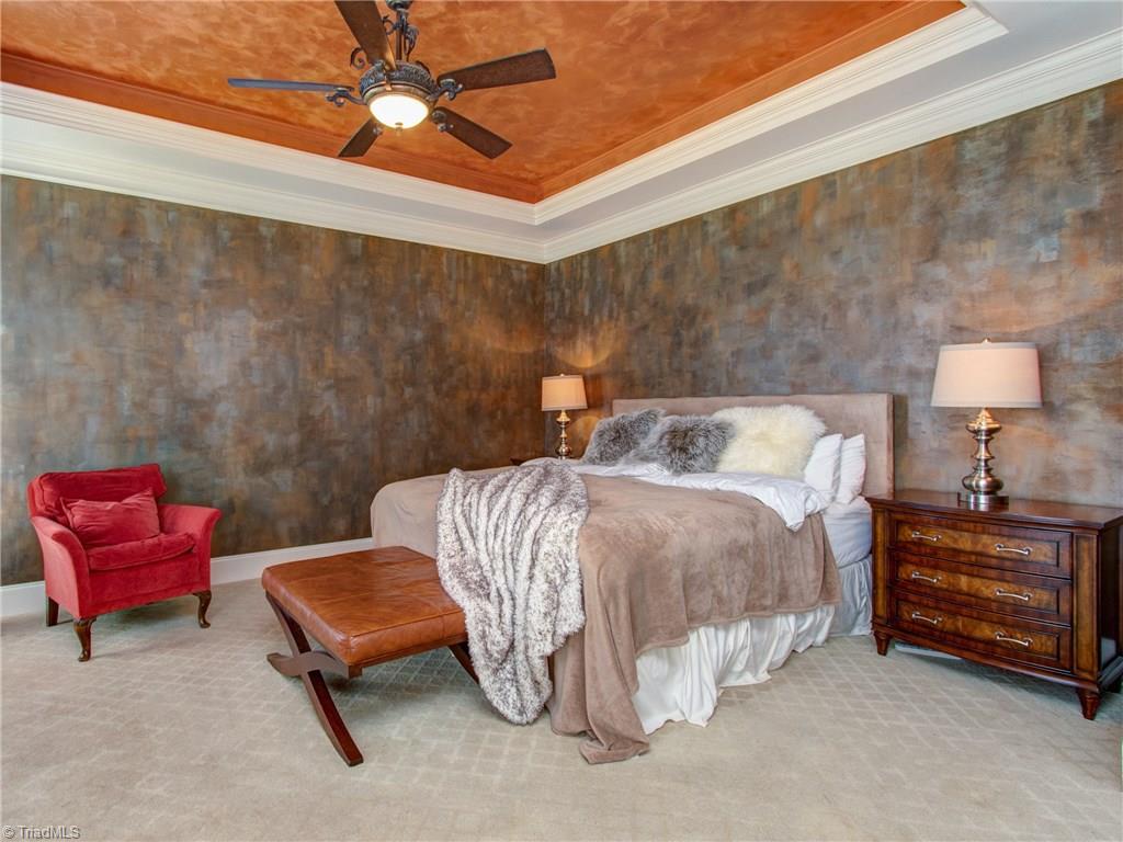 8404 Oakchester Court Oak Ridge, NC 27310 - Photo 8 of 30 Cozy master bedroom with crown molding, tray ceiling and recessed lighting.