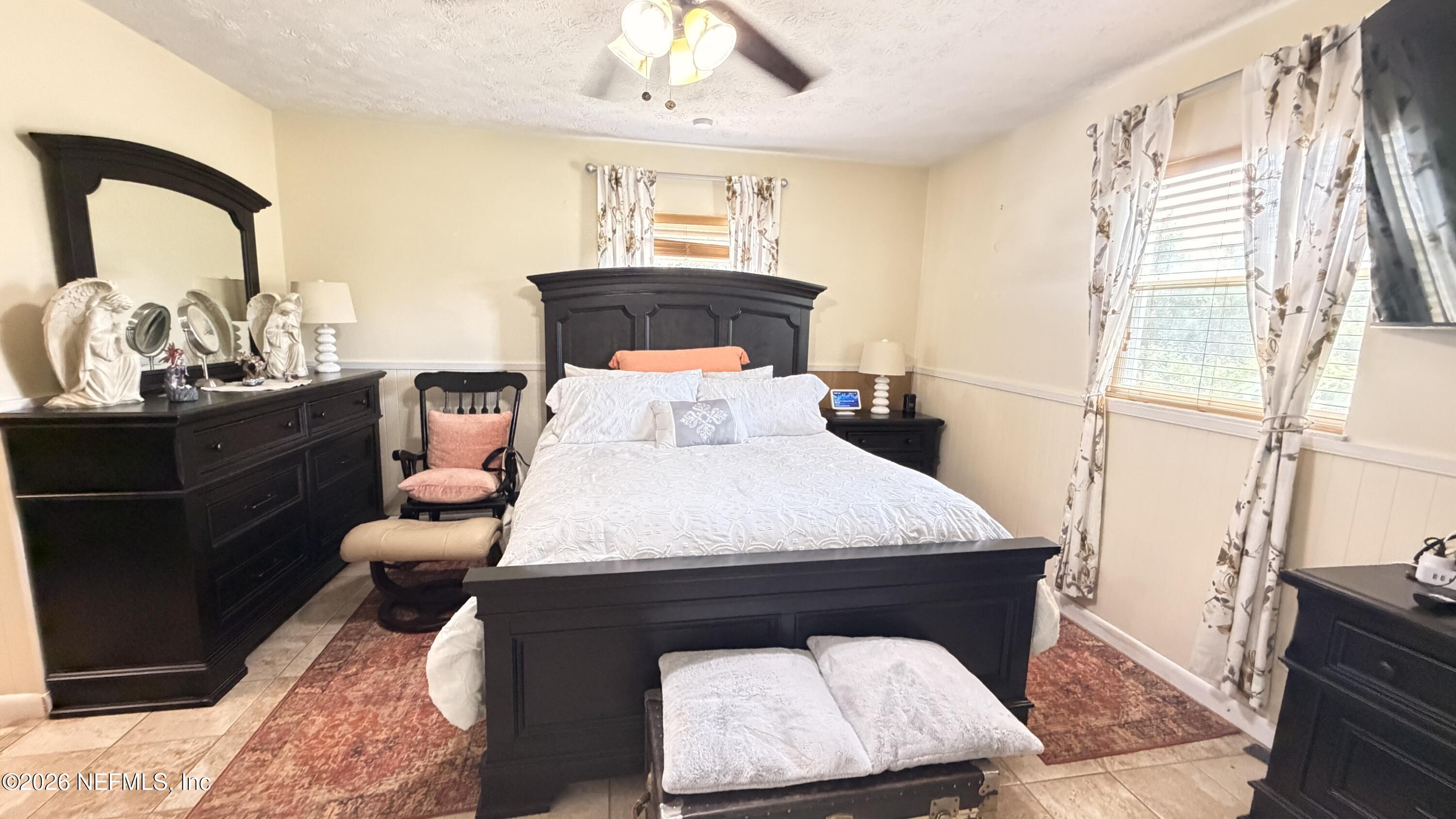 1302 Fort Meade Road Frostproof, FL 33843 - Photo 30 of 39 a bed sitting in a bedroom next to a window