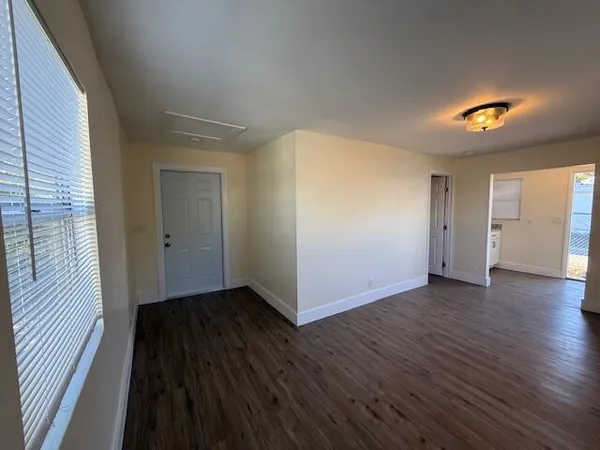 a view of a hallway with wooden floor