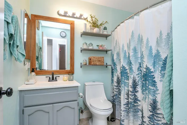 a bathroom with a toilet sink and mirror
