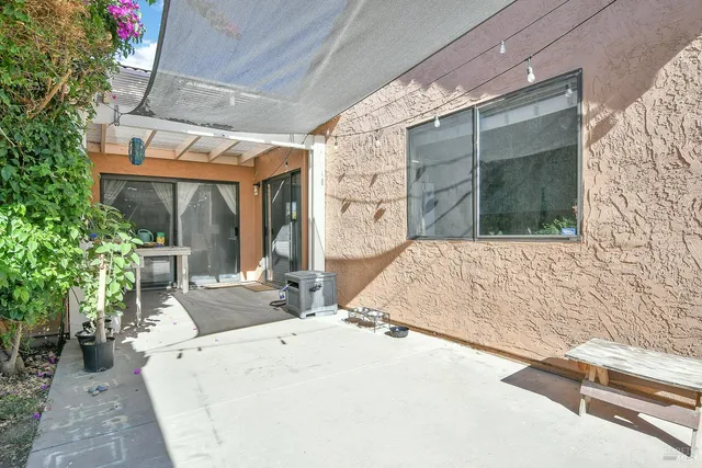 a view of patio with couches and potted plants