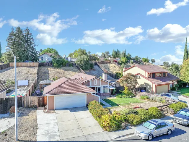a aerial view of a houses with a yard
