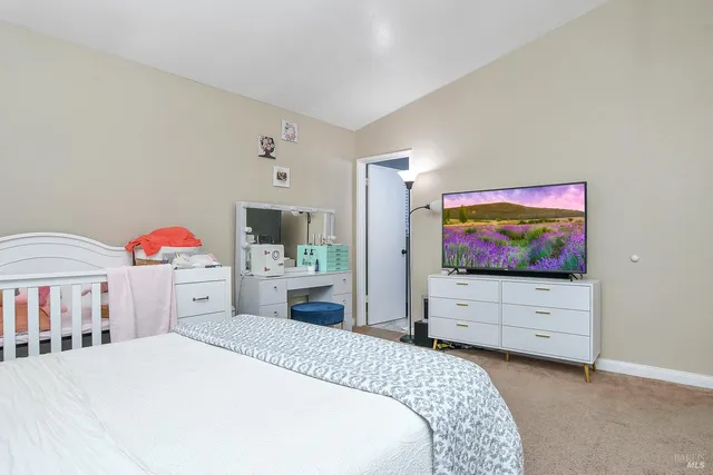a bedroom with furniture and a flat screen tv