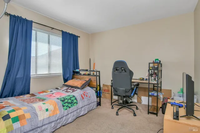 a bedroom with furniture and a window