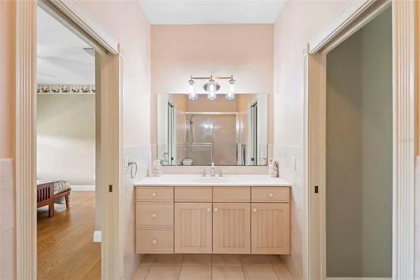 a spacious bathroom with a tub sink shower and mirror