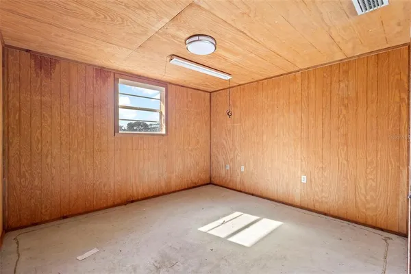 a view of a big yard with large trees