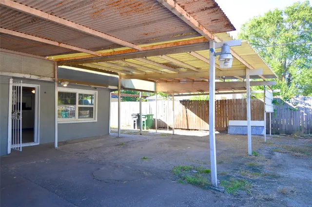 a view of an house with backyard and a porch