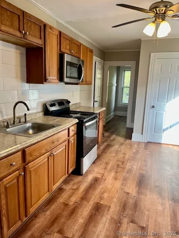 a kitchen with granite countertop a sink and a stove top oven