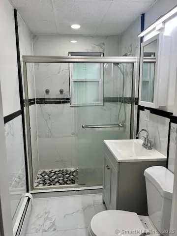 a bathroom with a sink toilet and shower
