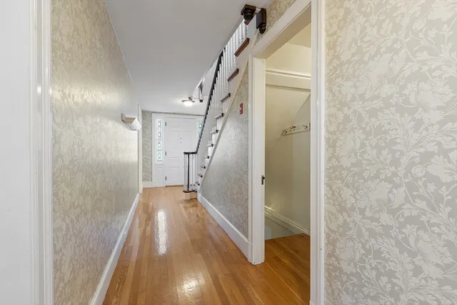 a view of entryway and hall with wooden floor