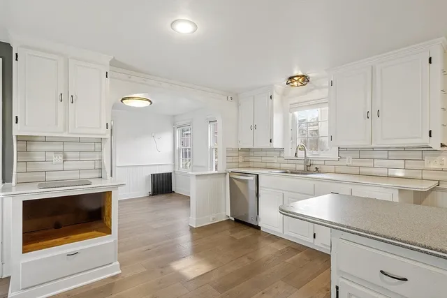 a kitchen with granite countertop cabinets stainless steel appliances and a sink