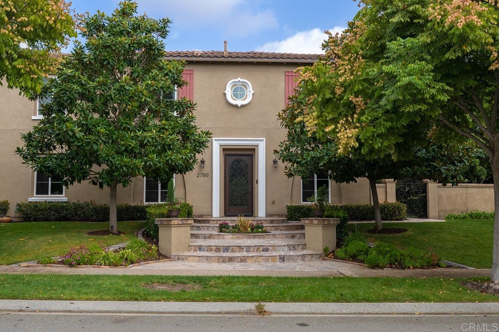 a front view of a house with garden