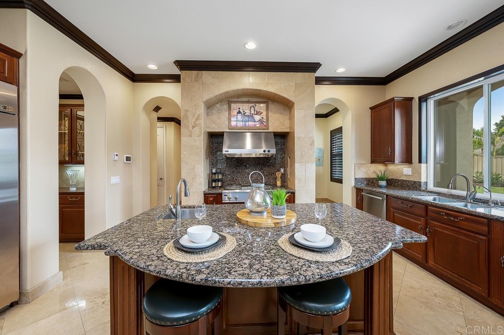 2786 Sutter Ridge Drive Chula Vista, CA 91914 - Photo 13 of 58 a view of a kitchen area with granite countertop a table and chairs in it