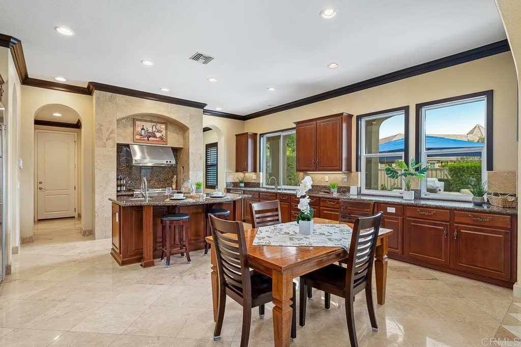 2786 Sutter Ridge Drive Chula Vista, CA 91914 - Photo 15 of 58 a dining hall with stainless steel appliances granite countertop a sink a stove a dining table and chairs