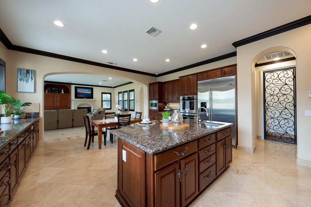 2786 Sutter Ridge Drive Chula Vista, CA 91914 - Photo 17 of 58 a kitchen with center island table and chairs in it