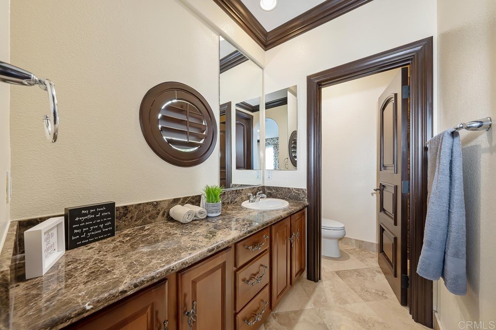 2786 Sutter Ridge Drive Chula Vista, CA 91914 - Photo 43 of 58 a bathroom with a granite countertop sink and a mirror