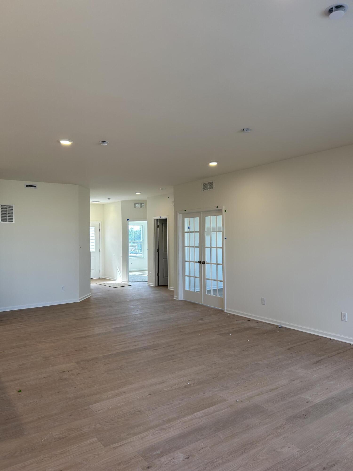 10357 Iowa Street Crown Point, IN 46307 - Photo 2 of 2 an empty room with wooden floor and windows