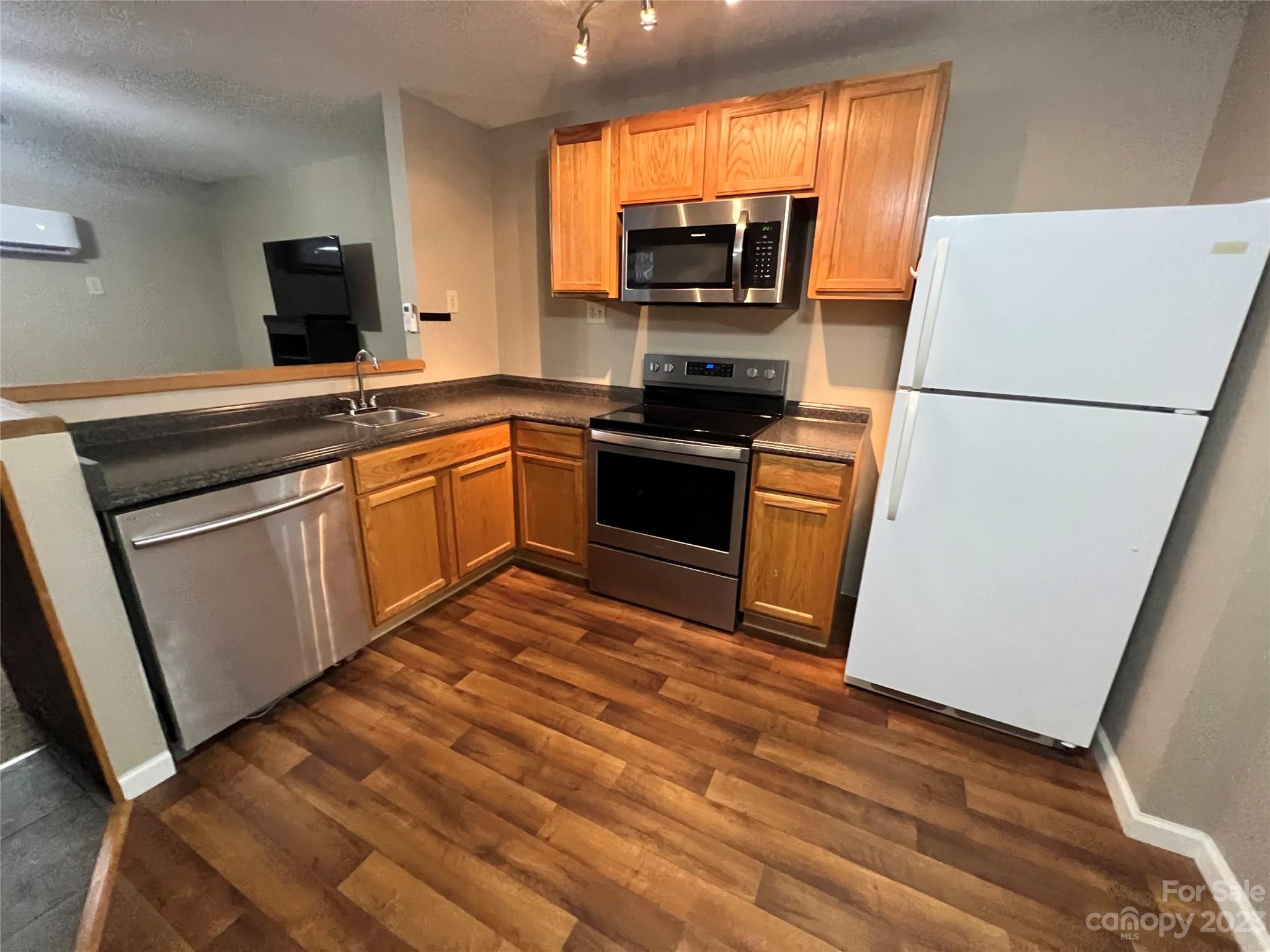 207 Whiteside Road Rutherfordton, NC 28139 - Photo 6 of 24 a kitchen with stainless steel appliances a stove refrigerator sink and microwave