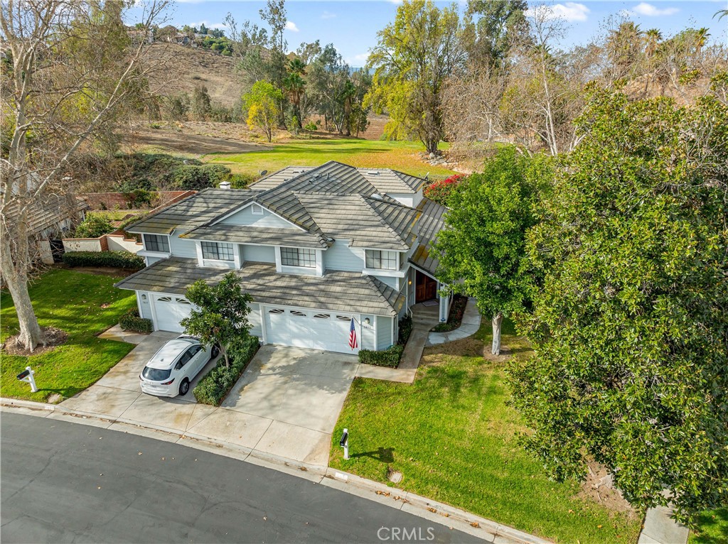 an aerial view of a house with a yard basket ball court and outdoor seating
