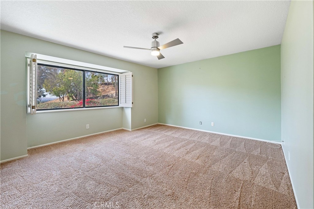 5855 Sunset Ranch Drive Riverside, CA 92506 - Photo 18 of 36 an empty room with windows and ceiling fan