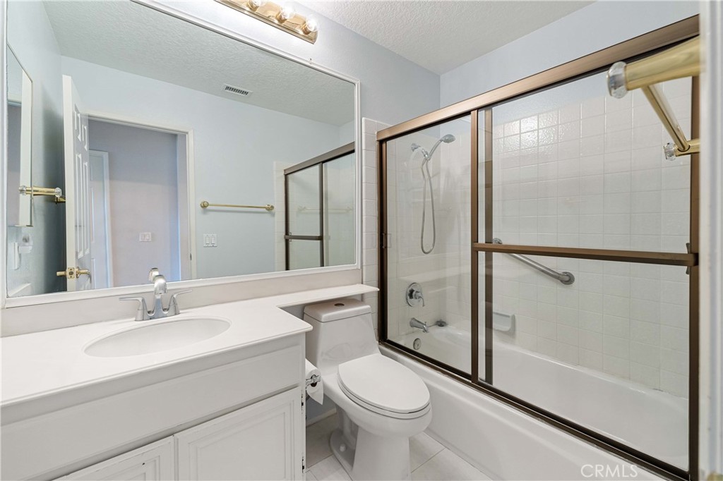 5855 Sunset Ranch Drive Riverside, CA 92506 - Photo 25 of 36 a bathroom with a sink toilet and shower