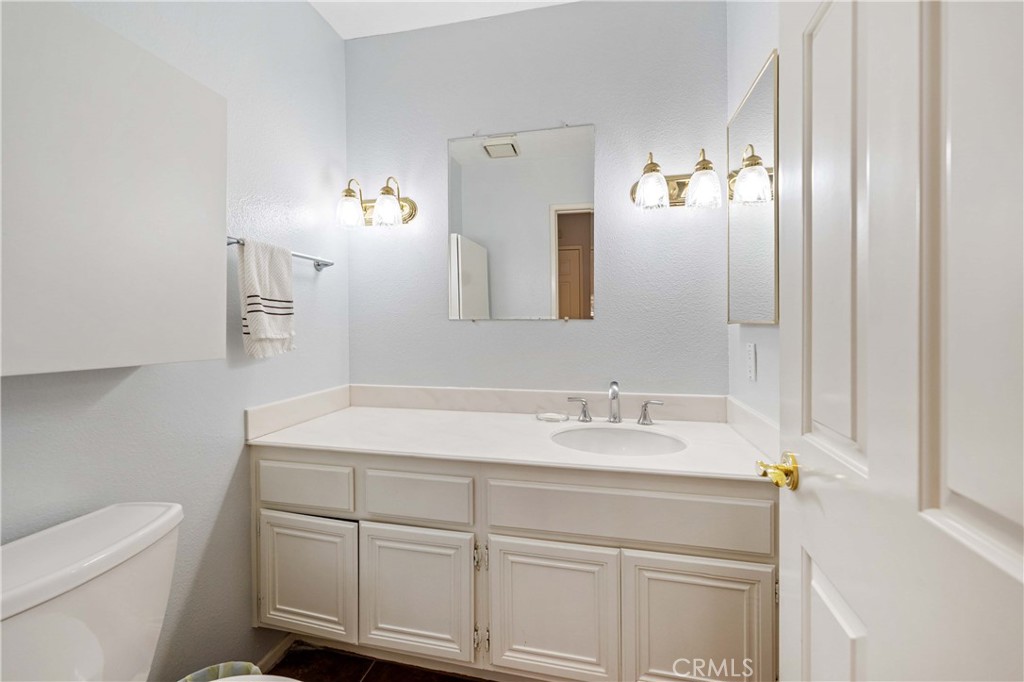 5855 Sunset Ranch Drive Riverside, CA 92506 - Photo 28 of 36 a bathroom with a sink vanity granite and toilet