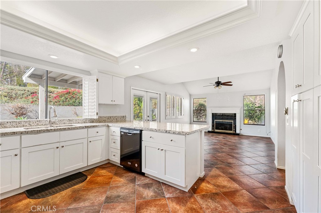 5855 Sunset Ranch Drive Riverside, CA 92506 - Photo 4 of 36 a large white kitchen with a stove top oven