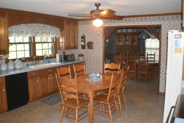 a dining room with a wooden table and chairs