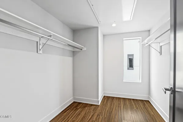 a view of a room with wooden floor and white walls
