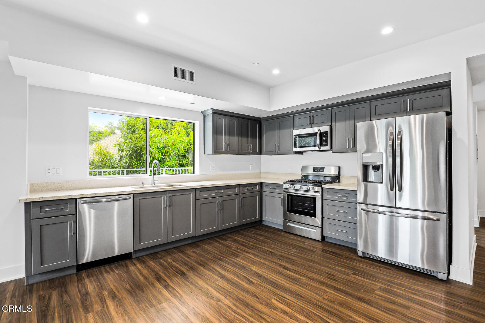 2000 Lake Avenue, Unit 4 Altadena, CA 91001 - Photo 10 of 20 a kitchen with stainless steel appliances granite countertop a refrigerator a stove top oven a sink and dishwasher with wooden floor