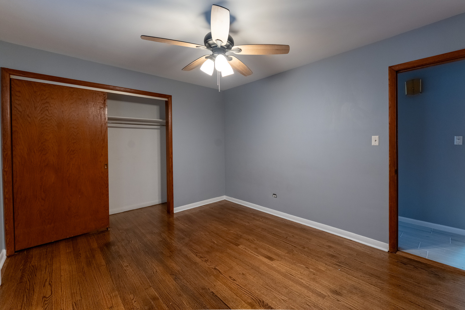 1440 Maple Avenue, Unit 1 Berwyn, IL 60402 - Photo 12 of 23 an empty room with wooden floor fan and windows