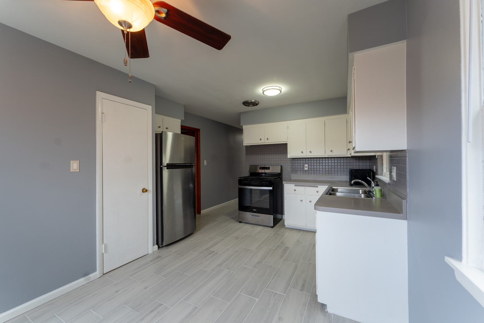 1440 Maple Avenue, Unit 1 Berwyn, IL 60402 - Photo 20 of 23 a kitchen with a refrigerator and a stove top oven
