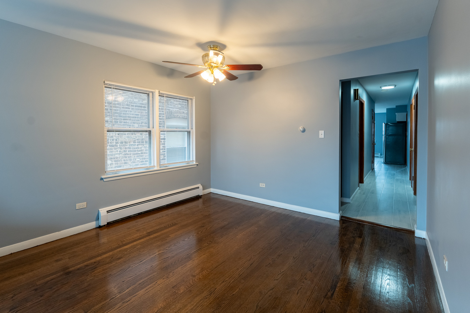 1440 Maple Avenue, Unit 1 Berwyn, IL 60402 - Photo 6 of 23 a view of an empty room with wooden floor and a window