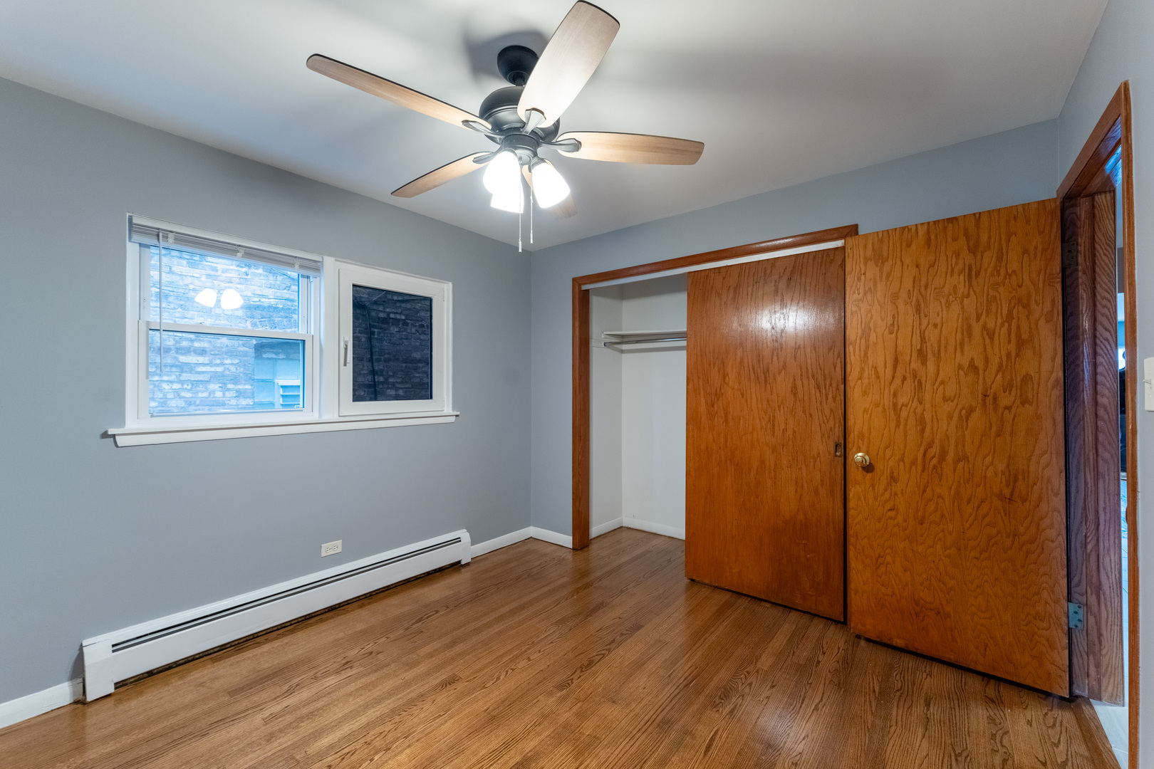 1440 Maple Avenue, Unit 1 Berwyn, IL 60402 - Photo 8 of 23 a view of an empty room with wooden floor and a window