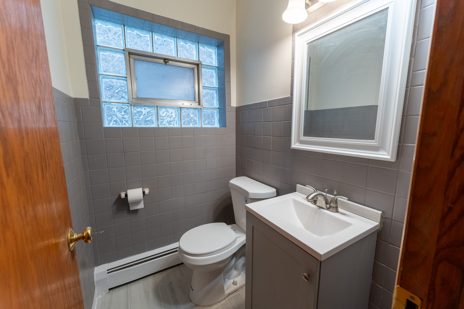 1440 Maple Avenue, Unit 1 Berwyn, IL 60402 - Photo 9 of 23 a bathroom with a toilet sink and mirror