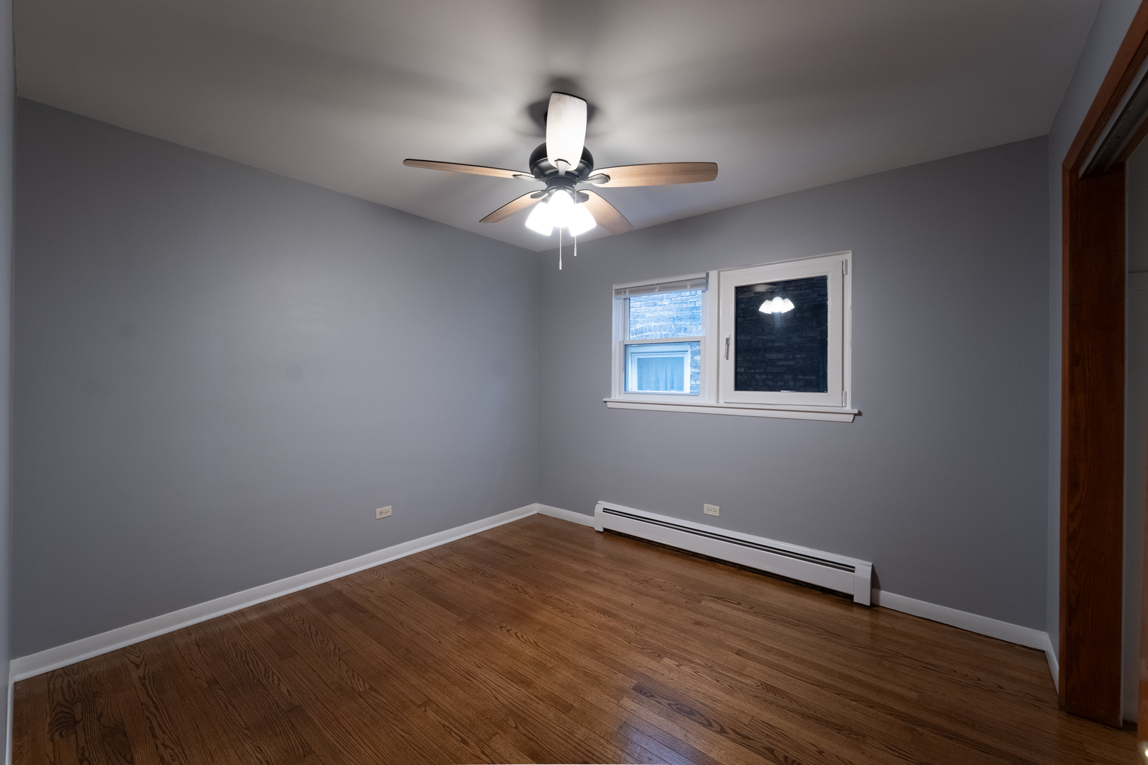 1440 Maple Avenue, Unit 1 Berwyn, IL 60402 - Photo 10 of 23 a view of a room with wooden floor and a ceiling fan