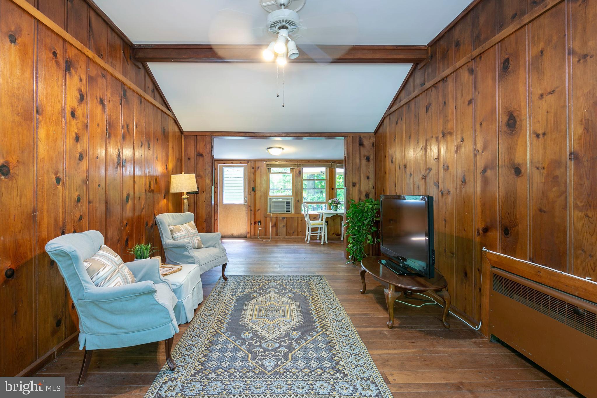 1430 Ravine Way Arnold, MD 21012 - Photo 4 of 29 Pine paneled living room with wood flooring and va
