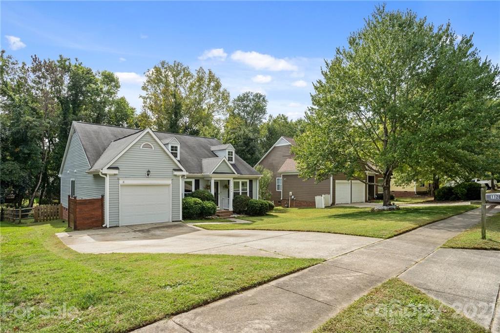 11204 Clayford Ridge Charlotte, NC 28215 - Photo 2 of 37 a front view of a house with a yard and trees