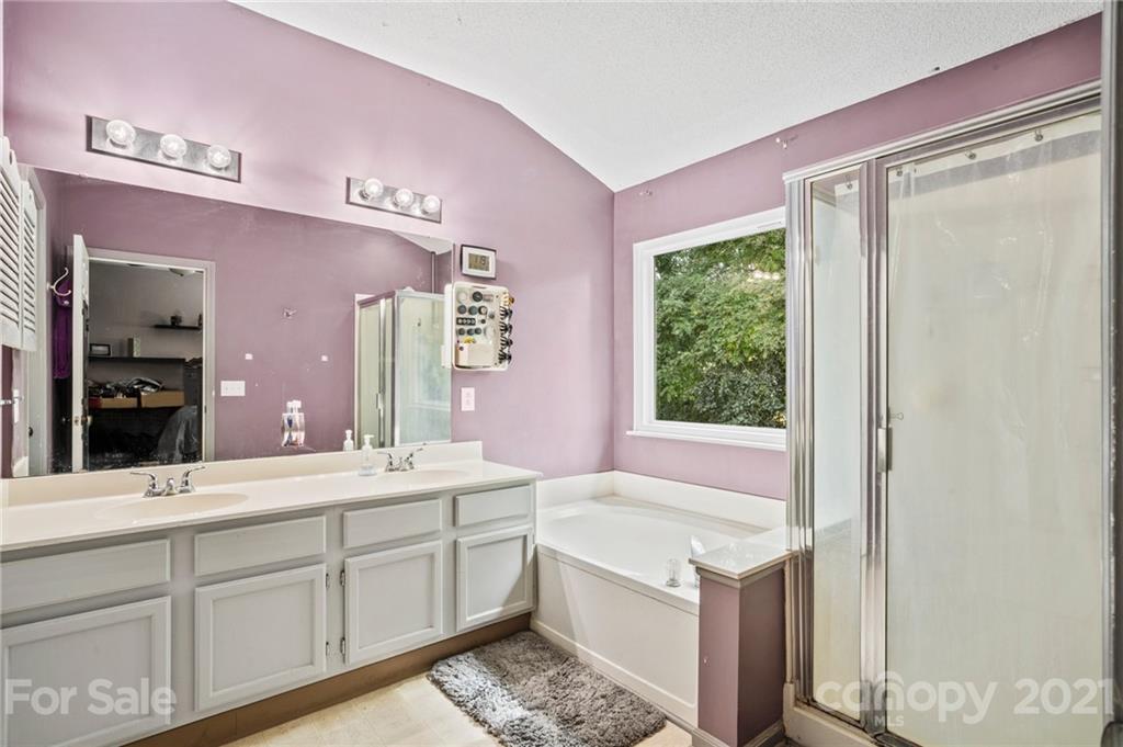 11204 Clayford Ridge Charlotte, NC 28215 - Photo 14 of 37 a bathroom with a granite countertop sink and a mirror