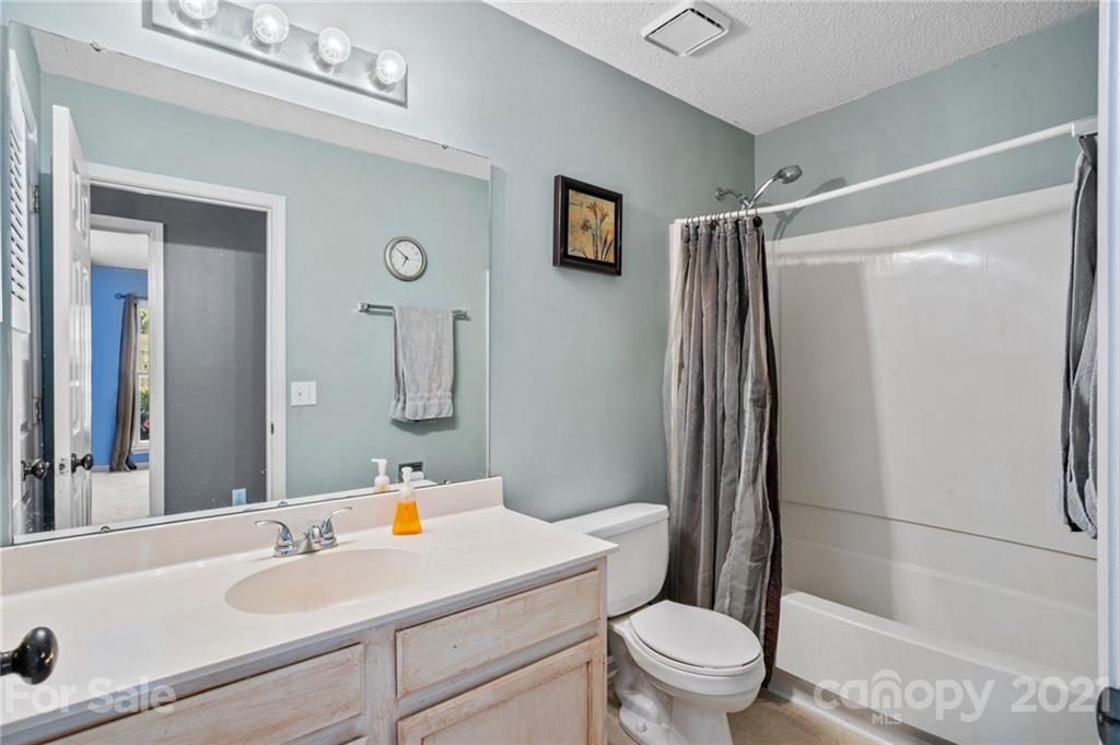 11204 Clayford Ridge Charlotte, NC 28215 - Photo 16 of 37 a bathroom with a sink toilet and shower