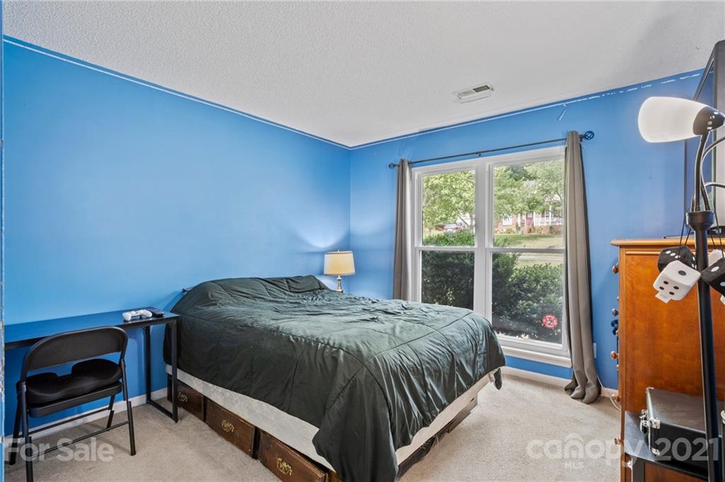 11204 Clayford Ridge Charlotte, NC 28215 - Photo 17 of 37 a bedroom with a bed and a window