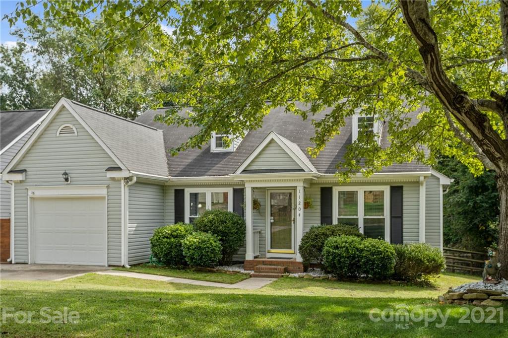 11204 Clayford Ridge Charlotte, NC 28215 - Photo 24 of 37 a front view of a house with a yard