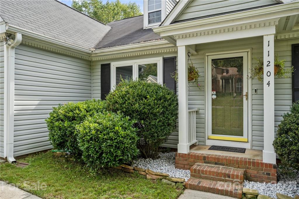 11204 Clayford Ridge Charlotte, NC 28215 - Photo 34 of 37 a front view of a house with garden