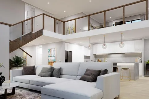 a living room with furniture kitchen view and a chandelier