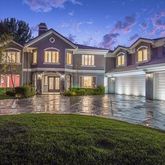 a view of a big yard with large tree and plants