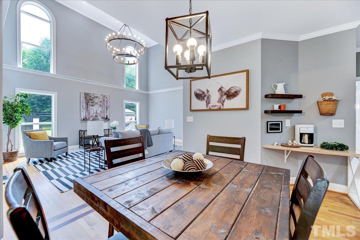 7033 Daniel Road Wake Forest, NC 27587 - Photo 19 of 63 a living room with furniture and a chandelier