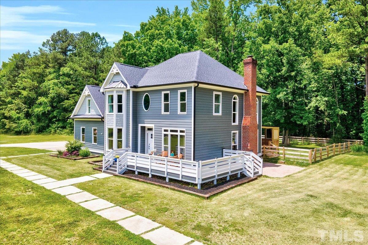 7033 Daniel Road Wake Forest, NC 27587 - Photo 2 of 63 a front view of a house with a yard table and chairs
