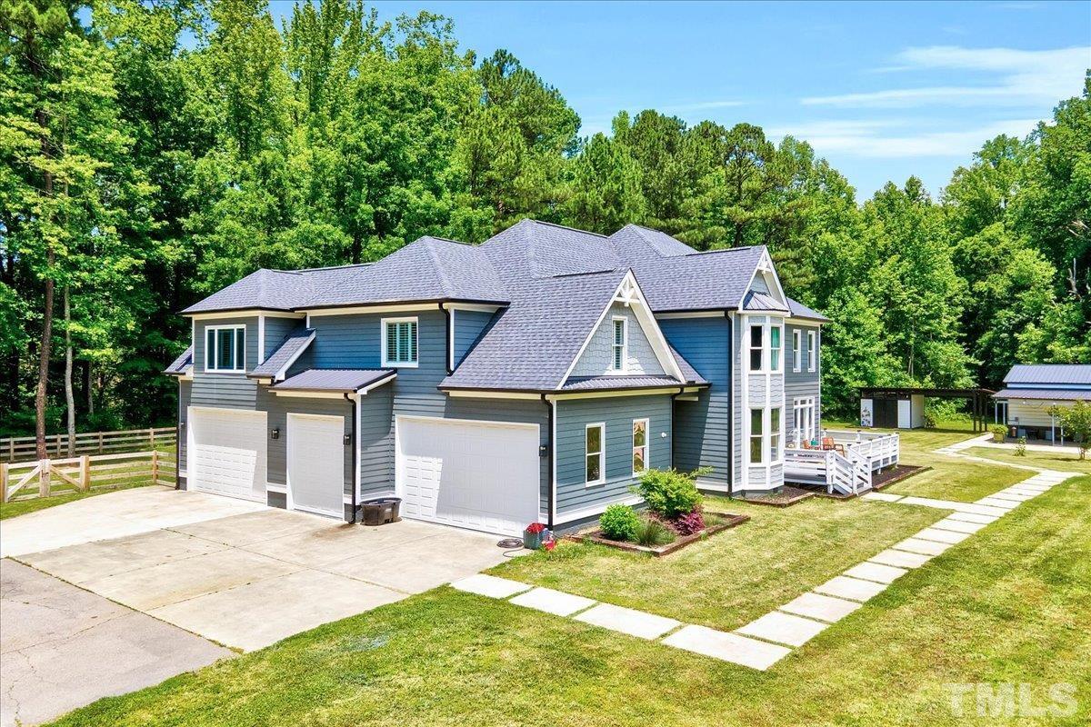 7033 Daniel Road Wake Forest, NC 27587 - Photo 3 of 63 a front view of a house with a yard table and chairs
