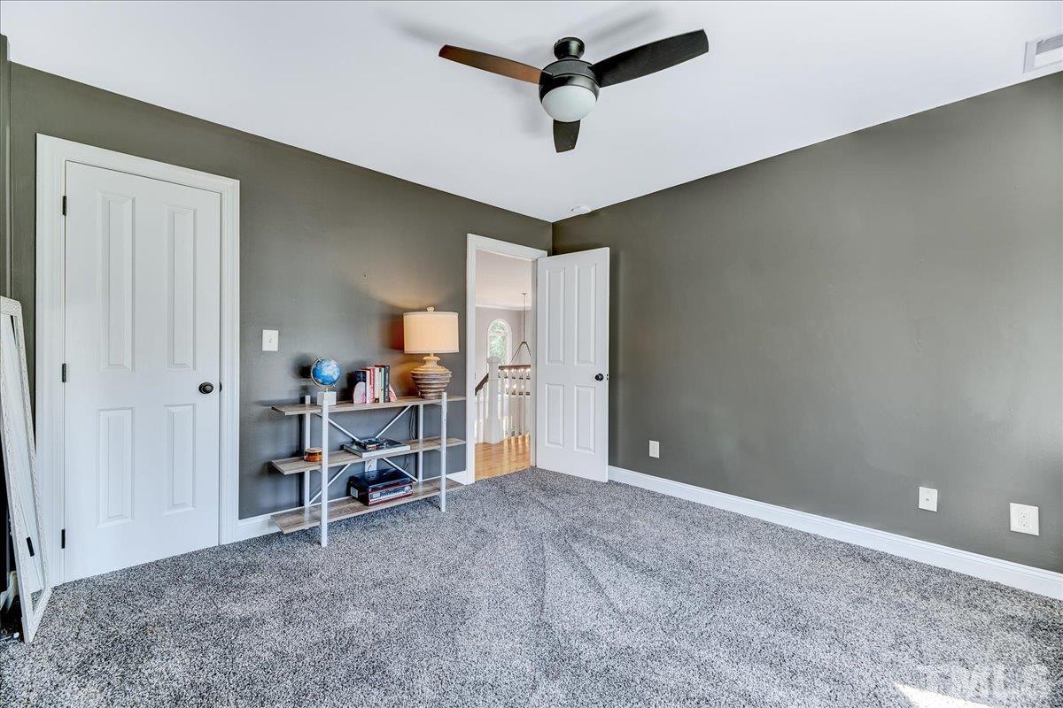 7033 Daniel Road Wake Forest, NC 27587 - Photo 31 of 63 a view of a livingroom with furniture and a ceiling fan